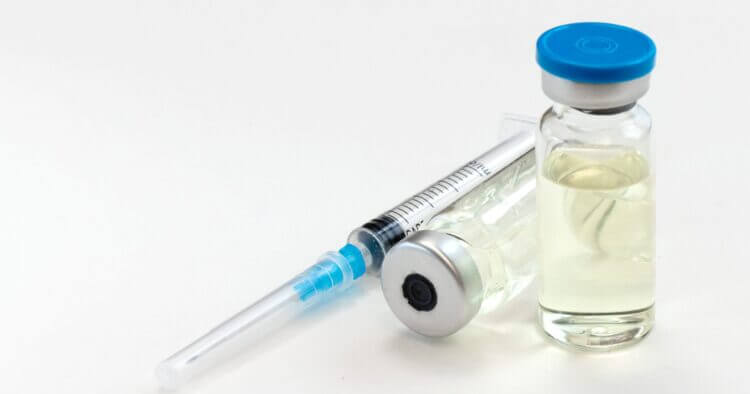 An image of a medication bottle and syringe