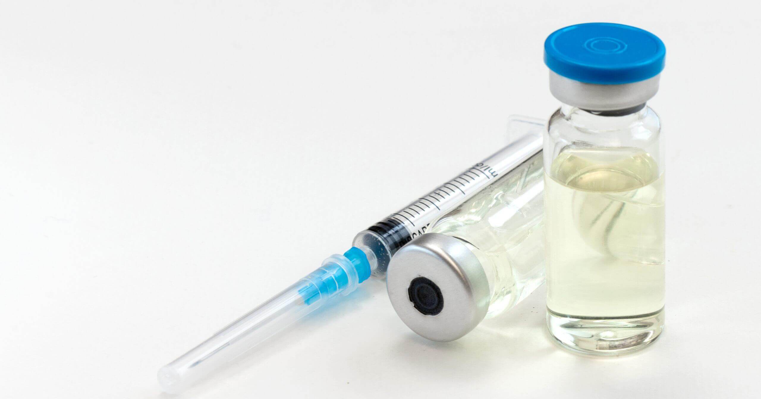 An image of a medication bottle and syringe