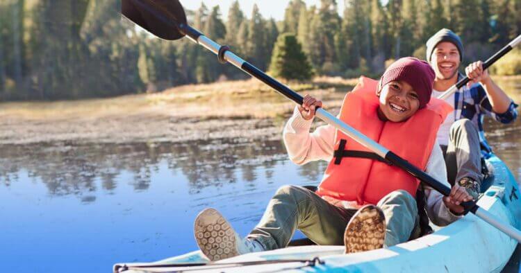 Young men in a canoe, smiling