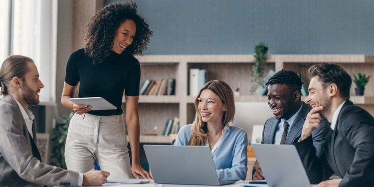 A group of young professionals chatting in a conference room